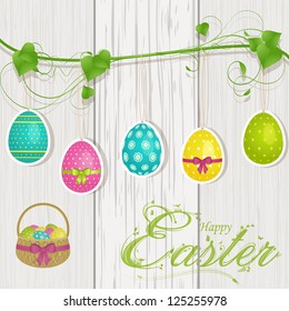 Easter Background with Hanging Easter Eggs and Basket on Wood