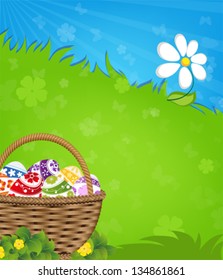  Easter basket with painted eggs  on a green meadow