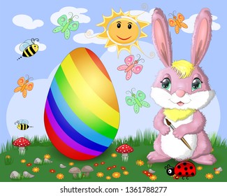 Easter bunny with a brush paints huge Easter egg on glade, the sun, butterflies, spring. Copy space