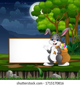 Easter bunny carrying a sack of easter eggs in front the blank sign