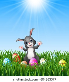 Easter bunny cartoon with Easter eggs in the grass on a background of bright sunshine                                               .Vector illustration