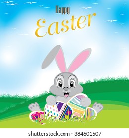 Easter bunny with colorful egg. Easter eggs on the meadow And a beautiful sky. Happy Easter Day.