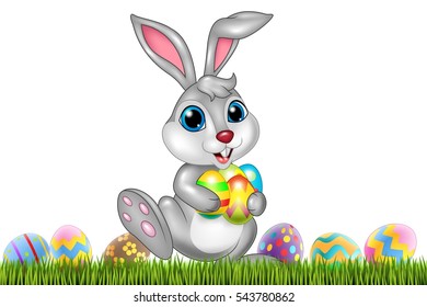 Easter bunny with decorated Easter eggs in a field