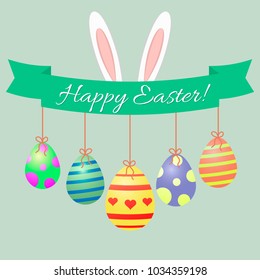 Easter bunny ears, green ribbon and Easter eggs. Congratulations Happy Easter.