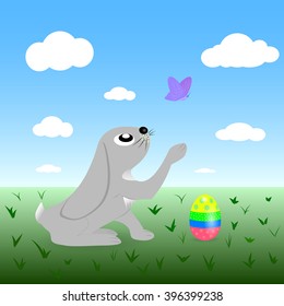 Easter bunny with Easter egg is playing with a butterfly in a field. Easter background