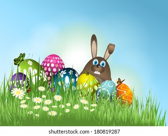 Easter bunny and eggs nestled in grass and flowers