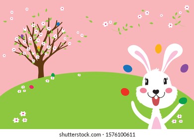 Easter bunny and Easter eggs on spring green grass and sweet flowers. Cute rabbit. Easter egg hunt.