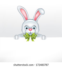 easter bunny with green bow holding blank paper sheet 