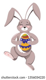 Easter bunny with happy expression on face holding painted egg vector hare with long ears and furry coat walking and carrying traditional decoration on spring holiday celebration in flat style