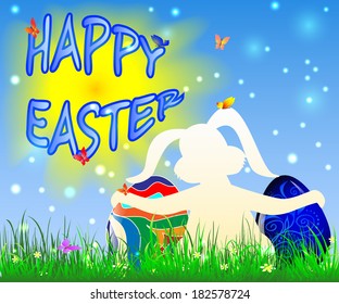 Easter bunny holding Easter eggs on the background of blue sky and green grass sun