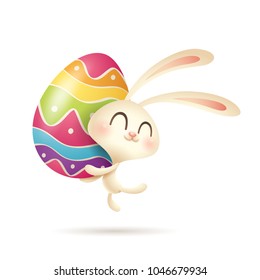 Easter bunny jumps up with a painted egg.