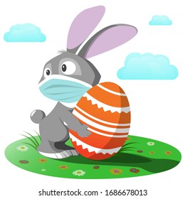 Easter bunny in a medical mask. A gray rabbit is holding an orange Easter egg in his hands.