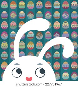 Easter bunny on a background of painted eggs.