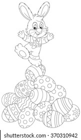 Easter Bunny on top of a pile of painted eggs