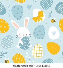 Easter bunny and painted eggs cute pattern. Blue and yellow seamless baby pattern for textile, apparel, fabric, nursery.