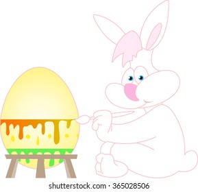 Easter bunny painting a big Easter egg