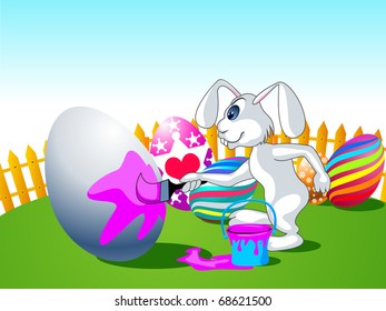 Easter bunny painting an egg