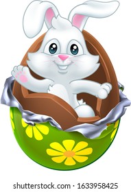 The Easter bunny rabbit breaking out of a chocolate egg