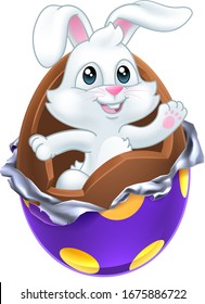 The Easter bunny rabbit breaking out of a chocolate egg