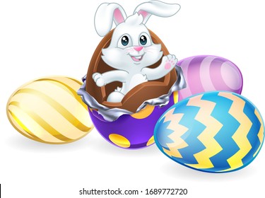 The Easter bunny rabbit breaking out chocolate Easter egg surrounded by more eggs