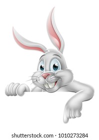 The Easter bunny rabbit cartoon character peeking over a sign and pointing down at it