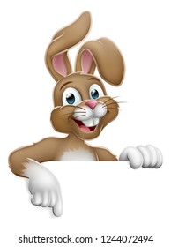 The Easter bunny rabbit cartoon character peeking around a sign and pointing at it