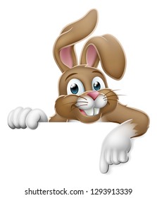 The Easter bunny rabbit cartoon character peeking around a sign and pointing at it