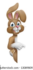 The Easter bunny rabbit cartoon character peeking around a sign and pointing at it