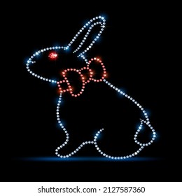 Easter bunny silhouette with red bow. Made from gemstones diamonds with rhinestones isolated on a black background. On a black background. Vector illustration.