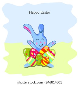 Easter bunny sitting among eggs on the background of sky and grass