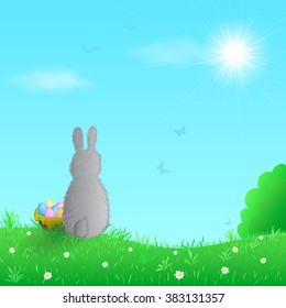 Easter bunny sitting on the green meadow. Vector illustration.