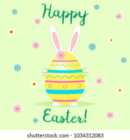 The Easter bunny stands behind a yellow decorative egg. Congratulations on Easter.