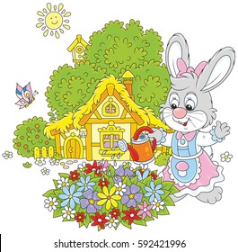 Easter Bunny watering beautiful flowers in a flowerbed in front of its farmhouse