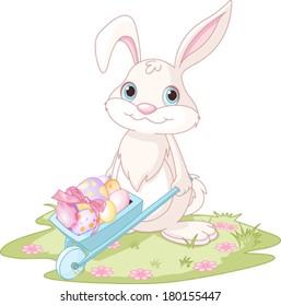 Conejo de Pascua con carretilla llena de huevos