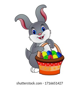 An Easter bunny white rabbit with a basket of painted chocolate Easter eggs