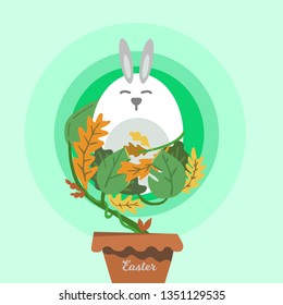 Easter bunny wrapped with leaves on a green background.