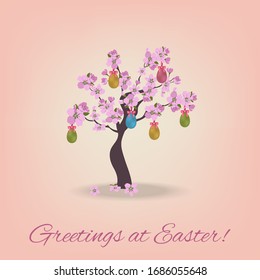 Easter card with greeting text and blooming cherry decorated with easter eggs.