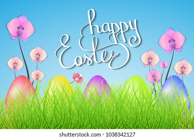 Easter card. Hand lettering, Easter eggs, green grass and sky, flowers.