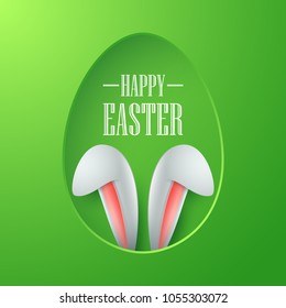 Easter card with paper egg shape frame with bunny ears in egg hole on green background
