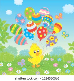 Easter Chick with colorful balloons on a green lawn among flowers on a sunny spring day, vector illustration in a cartoon style