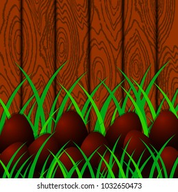 Easter. Chocolate eggs on the background of wood and grass. Place for text