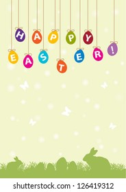 Easter colored eggs with rabbits on grass
