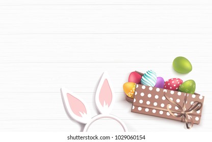 Easter colorful eggs in gift box and bunny ears on white wooden background. Beautiful spring background with place for text. Vetor illustration