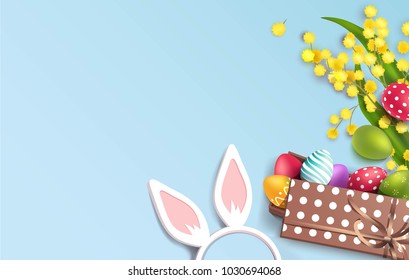 Easter colorful eggs in gift box, mimosa branch and bunny ears on blue background. Beautiful spring background with place for text. Vector illustration
