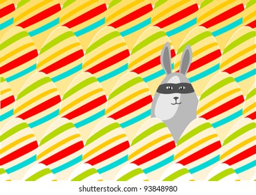 Easter is coming: masked egg-shaped rabbit hides among many Easter eggs, looking naughty and mischievous - vector image