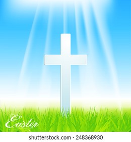Easter Cross with Grass and Text on Blue Sky Background