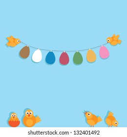 easter decoration with yellow chicks and paper eggs on blue background
