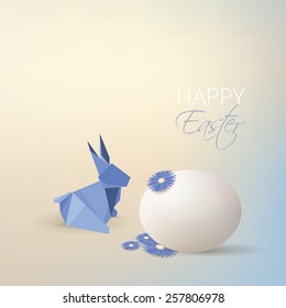 Easter egg, aster flowers and blue origami rabbit decoration isolated on soft subtle blurry background