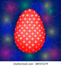 Easter egg decorated with beads and stars on bokeh