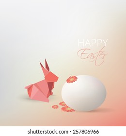 Easter egg, gerbera flowers and pink origami rabbit decoration isolated on soft subtle blurry background 